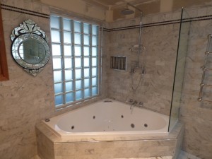 Photo of Thornton Italian styled bathroom with a corner spa