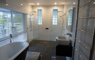Completed photos of an ensuite renovation at Farley with a freestanding bath on a platform with a double ended shower