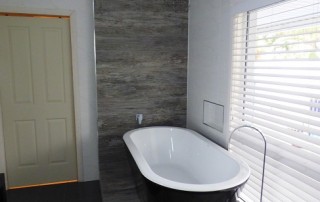 Completed photos of an ensuite renovation at Farley with a freestanding bath on a platform